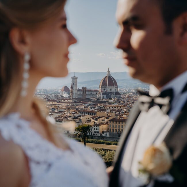 Elegant couple posing at sunset with Florence skyline and Duomo in the background