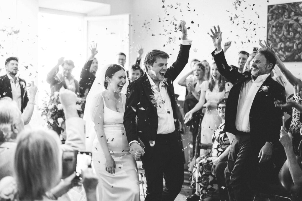 Joyful rice toss moment at a destination wedding in Tuscany