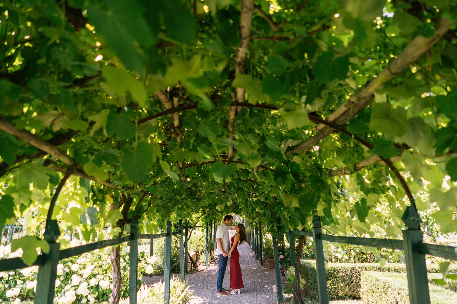 Couple embracing after proposal with flower bouquet