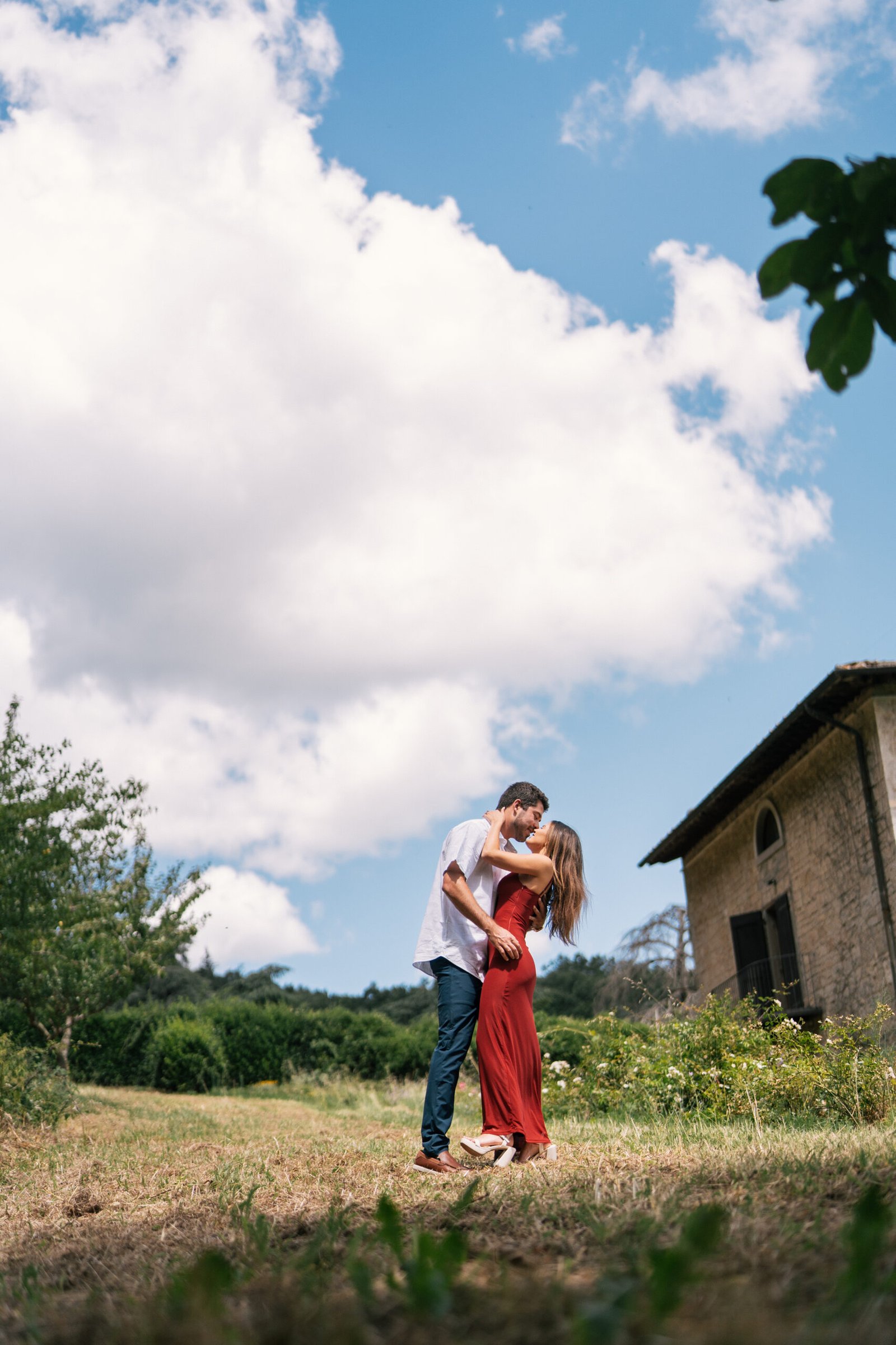 Intimate moment after proposal in Tuscany garden