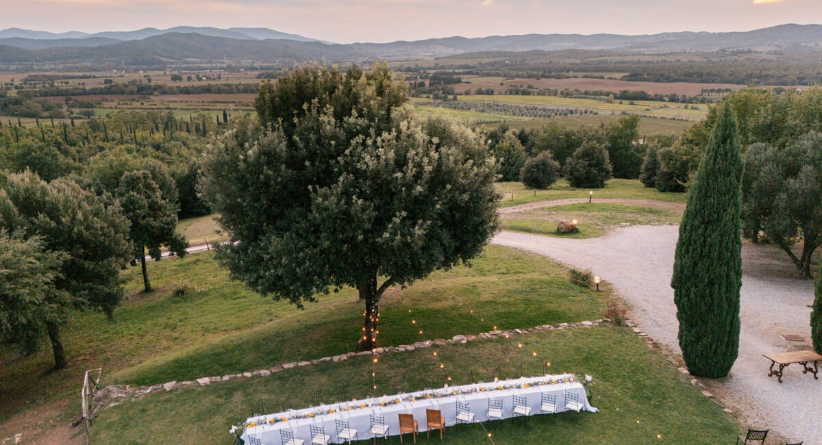 Candid moment during a wedding dinner under fairy lights in Tuscany