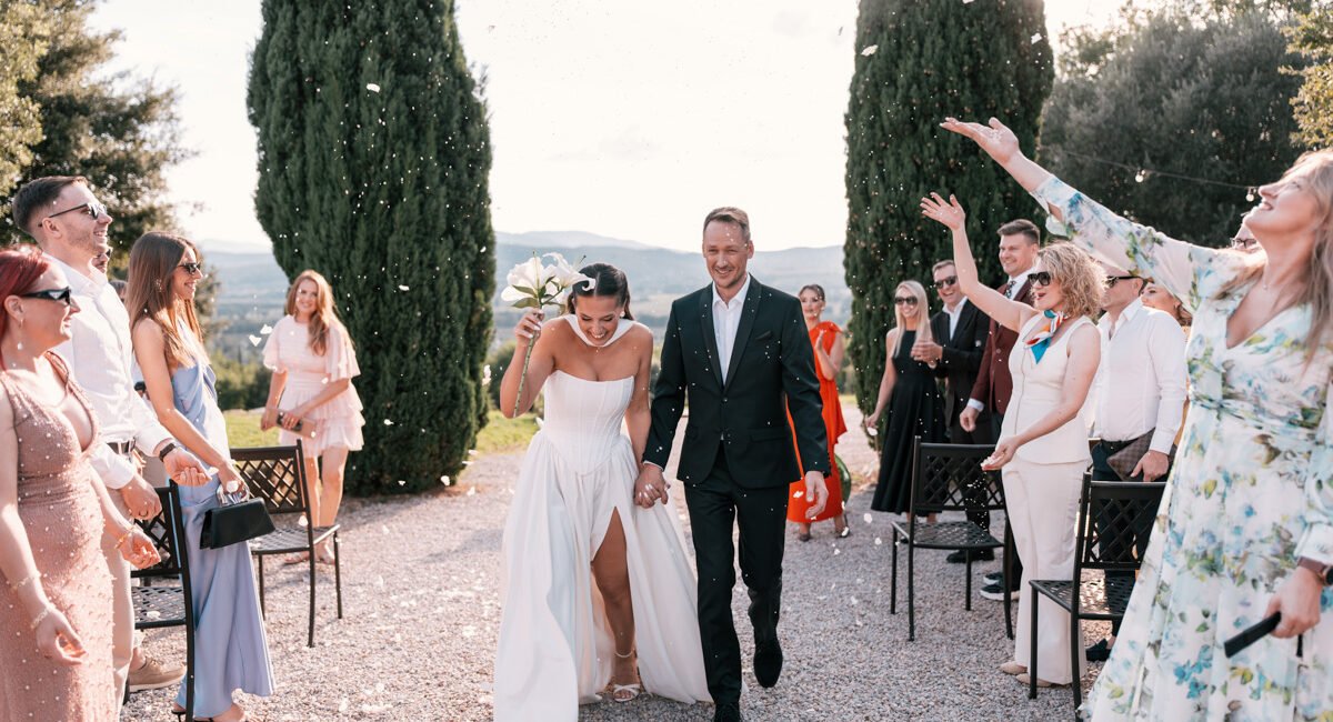 Romantic outdoor wedding ceremony overlooking Tuscan hills in Italy